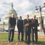 David Mitchell speaks on Capitol Hill as (from left) Sen. Bernie Sanders, Rep. Elijah Cummings and Lloyd Doggett look on.